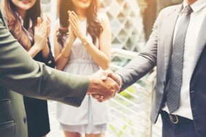 business people shaking hands finishing up a meeting success deal 1150 2552