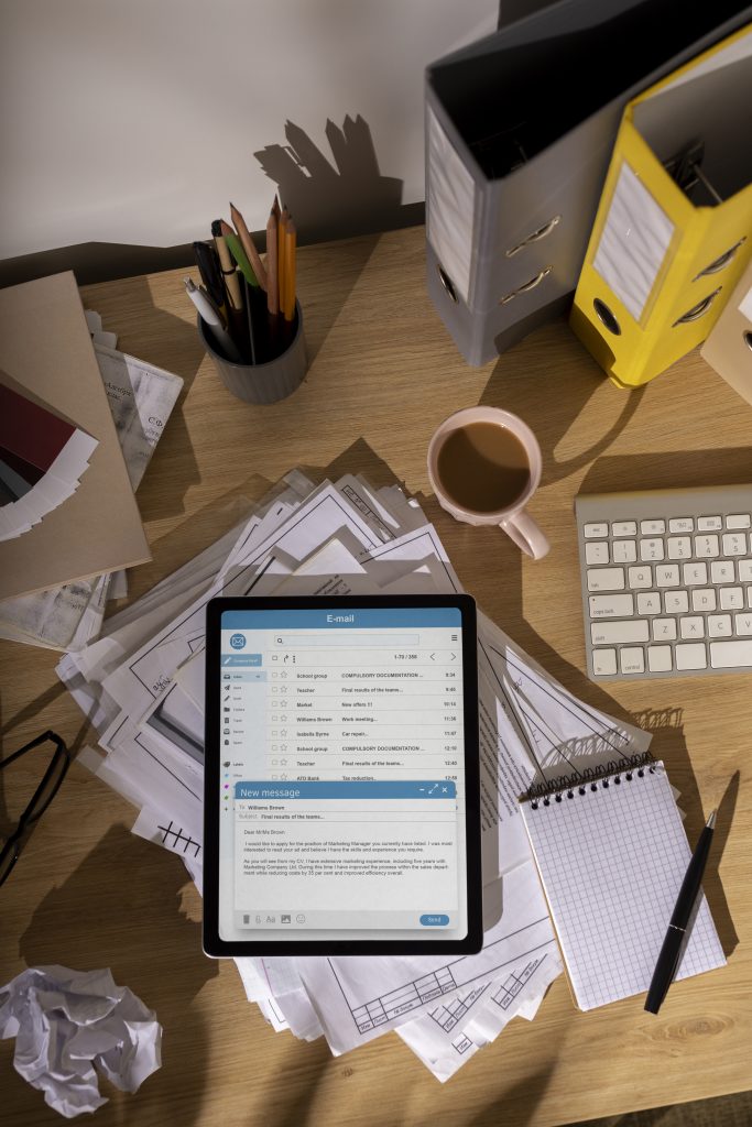top view messy office workspace with tablet
